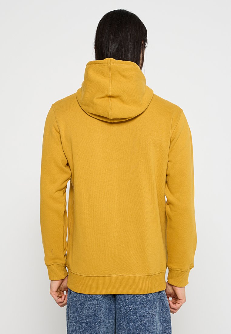 Felpa con cappuccio giallo senape, con una finitura testurizzata, polsini e orlo a costine, dal taglio rilassato e con tasche a marsupio.