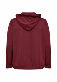 Sudadera marrón con capucha con volantes, mangas largas y una cinturilla ajustada. Fabricada en un tejido suave con una textura lisa y un color sólido.
