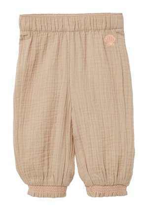 Pantalons en coton beige clair avec tissu texturé, taille élastique et poignets froncés. Présente une petite broderie en forme de coquillage rose sur la hanche.