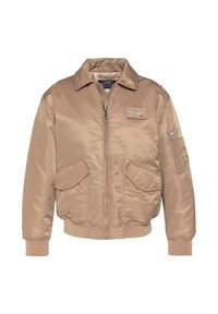 Tanfarbener Bomberjacke aus glattem Nylon mit Reißverschluss vorne, großen Fronttaschen und gerippten Bündchen sowie Saum. Mit einem Logo-Patch auf der Brust.