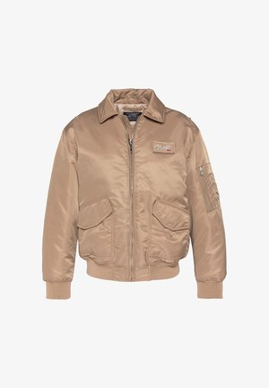 Tanfarbener Bomberjacke aus glattem Nylon mit Reißverschluss vorne, großen Fronttaschen und gerippten Bündchen sowie Saum. Mit einem Logo-Patch auf der Brust.