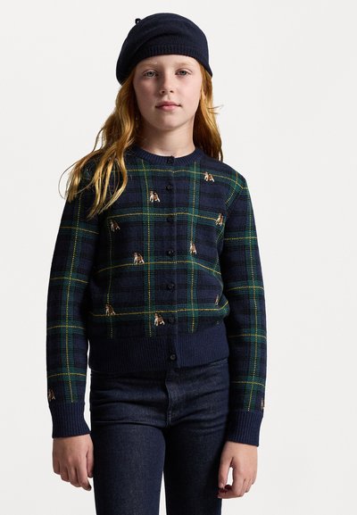Marine cardigan med grønn og gul rutete mønster med små broderte hundedesign. Ribbede mansjetter og kant. Knapplukking.