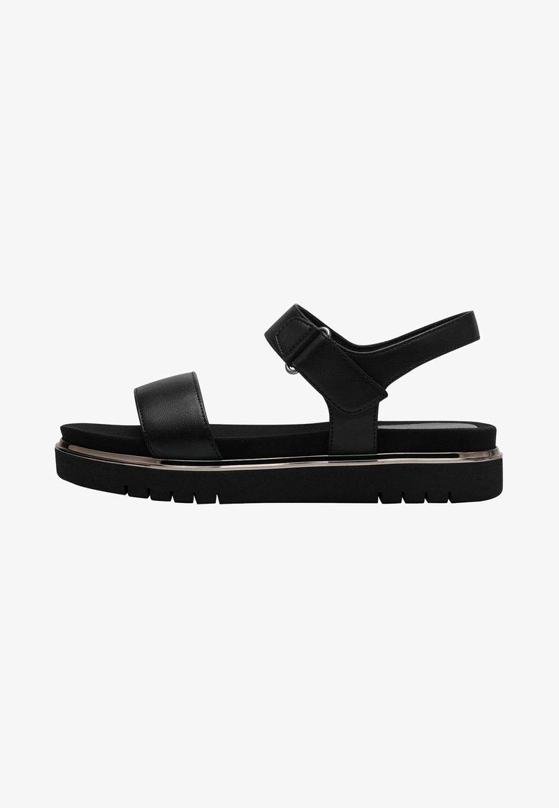 Black sandals with a flat sole, wide front strap, and adjustable ankle strap. Features a metallic accent along the sole for added detail.