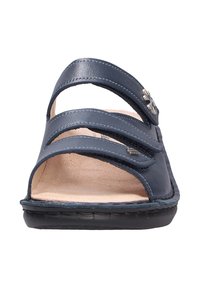 Navy blue leather sandal with three adjustable straps, open toe design, beige footbed, and textured black sole. Metal accent detail.