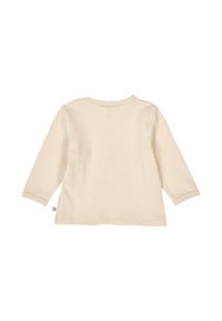 Light beige long-sleeve cotton shirt with a round neckline and straight cut. Features minimalist design, stitched hems, and a small tag.