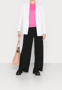 Bílý blazer, jasně růžový žebrovaný pletený top, černé široké kalhoty, černé platformové boty a béžová kabelka. Jednoduchý, moderní design.