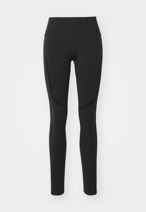 Schwarze Leggings mit hoher Taille, glattem Stoff und kontrastierenden Seitenpanelelementen. Enganliegendes Design bis zur Knöchellänge.