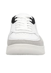 White sneaker with black and grey accents, featuring a smooth leather upper, suede detailing, and white laces. Rounded toe and cushioned sole.