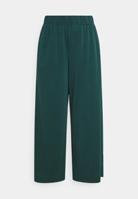 Pantalons à jambes larges en tissu doux de couleur vert foncé. Dotés d'une taille élastique et d'un design simple, sans embellissements et sans poches visibles.