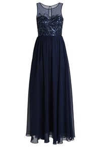 Lång marinblå klänning med en figursydd paljettoberdel, genomskinlig överdel och flödande kjol. Har en rund halsringning och en nyckelhålssned på ryggen.