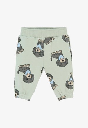 Pantalons en coton vert clair avec un motif répété de chiens en cartoon portant des bandanas bleus. Taille élastique et bas de jambes froncés.