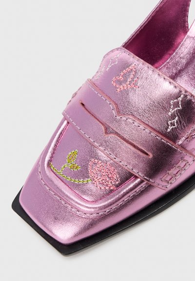 Mocassin rose métallique à bout carré, avec des designs floraux et de papillons brodés sur le dessus et une semelle noire.