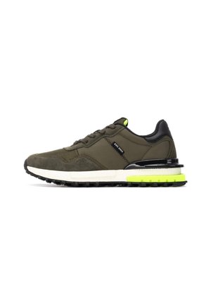 Zapatillas de ante y malla verde con acentos negros y una entresuela blanca, que cuentan con un tacón amarillo brillante y una suela de goma texturizada.