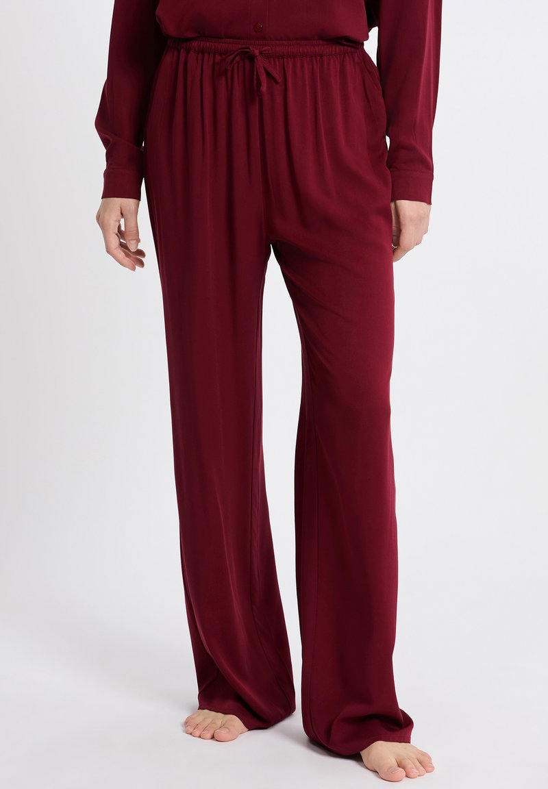 Bordeaux wijd-gesneden broek van zacht materiaal, met een elastische tailleband met drawstring en zijnaad voor een ontspannen pasvorm.