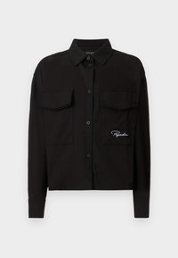 Black long-sleeve shirt made of cotton, featuring a button-down collar, two chest pockets, and embroidered logo on the left side.