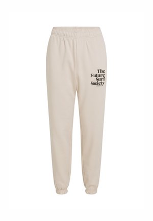 Beige katoenen sweatpants met een elastische tailleband, taps toelopende boorden en zwarte tekst die "The Future Surf Society" op het linkerbeen leest.