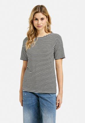 Black and white striped T-shirt with a crew neckline and short sleeves, made of soft fabric, worn with blue distressed denim jeans.