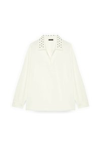 Polo a maniche lunghe bianco con colletto decorato con borchie nere. Realizzato in un tessuto morbido e con una vestibilità comoda, presenta una patta frontale e spacchi laterali.