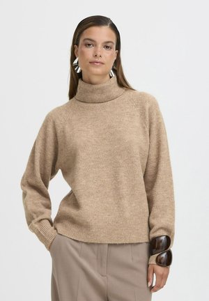 Maglione beige con collo alto, dalla vestibilità comoda e orlo a costine, caratterizzato da un hardware unico di accentuazione marrone scuro sulle maniche. Texture morbida.