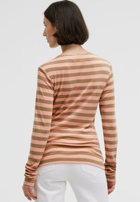 Long-sleeve shirt with horizontal stripes in light pink and beige, featuring a round neckline and fitted sleeves.
