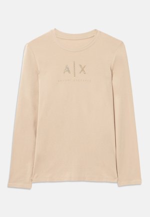 Long-sleeve, light beige shirt made of smooth fabric, featuring A|X logo embellished with clear rhinestones and round collar design.