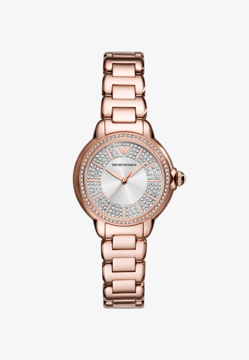 Kulta ruusukello, jossa on pyöreä kuori, metallinen tekstuuri kellotaulussa ja kristalliakoristeita. Ranneke on varustettu suurilla linkeillä, mikä antaa sille massiivisen ilmeen.