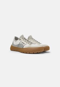 Lightweight sneakers in cream and gray mesh, featuring a rubber outsole, textured accents on the sides, and grey laces.