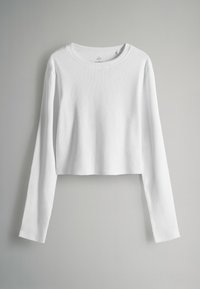 Balts, garais piedurknēm īsais tops, kas izgatavots no ribota auduma ar apaļu kakla izgriezumu. Gluda tekstūra un nav redzamu rakstu vai akcentu.