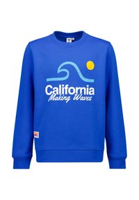 Sininen puuvillasekoitekangas, jossa on aallonkaltainen graafinen kuvio ja keltainen aurinko. Mukana logo-patch helman lähellä. Pyöreä pääntie, pitkät hihat.