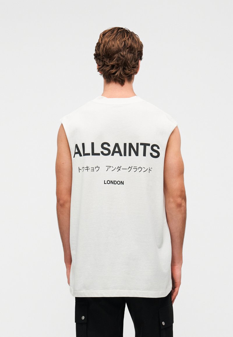Λευκό αμάνικο μπλουζάκι με έντονο μαύρο κείμενο στην πίσω πλευρά: «ALLSAINTS», ιαπωνικοί χαρακτήρες και «LONDON». Μαλακή, άνετη γραμμή.
