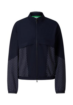 Navy blue zip-up jacket with geometric patterned panels on sleeves and sides, high collar, and elasticized hem and cuffs.