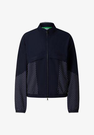 Granatowa kurtka na zamek z geometrycznymi panelami na rękawach i bokach, z wysokim kołnierzem oraz elastycznym ściągaczem u dołu i na mankietach.