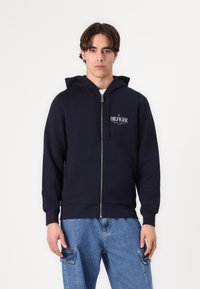 Tommy Hilfiger - STACKED HOODED ZIP UNISEX - Zip-up sweatshirt - desert sky Thumbnail Image 1