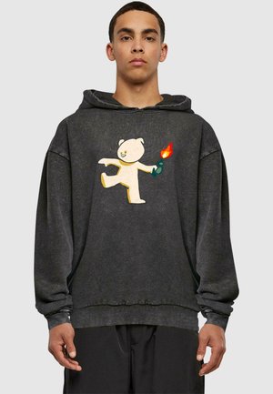 Gray oversized hoodie with a textured finish, featuring a graphic of a light-colored bear holding a lit flame. Adjustable drawstring hood.
