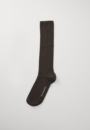 Brąsocki do kolan w kolorze brązowym z kwiatowym wzorem, wykonane z gładkiego materiału. Posiadają teksturowany wzór oraz logo w okolicy palców.