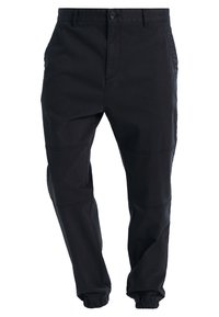 Black, lightweight fabric pants with tapered legs and elastic cuffs. Features side pockets and a button closure. Clean, simple design.