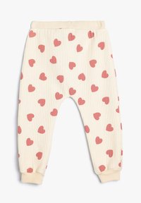 Helle, gerippte Hose in Cremefarbe mit verstreuten rosa Herzformen, elastischem Bund und Knöchelabschlüssen für eine bequeme Passform.