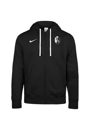 Schwarzer Kapuzenpullover mit Reißverschluss und weißen Kordeln, Nike-Logo auf der rechten Brust und Freiburg Fußballvereins-Emblem auf der linken Brust.