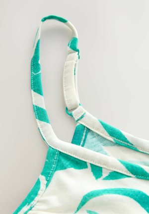 Vícebarevný ramínek tílka s tyrkysovým a bílým listovým vzorem, vyrobený z měkké látky s prošívanými detaily a nastavitelným kováním.