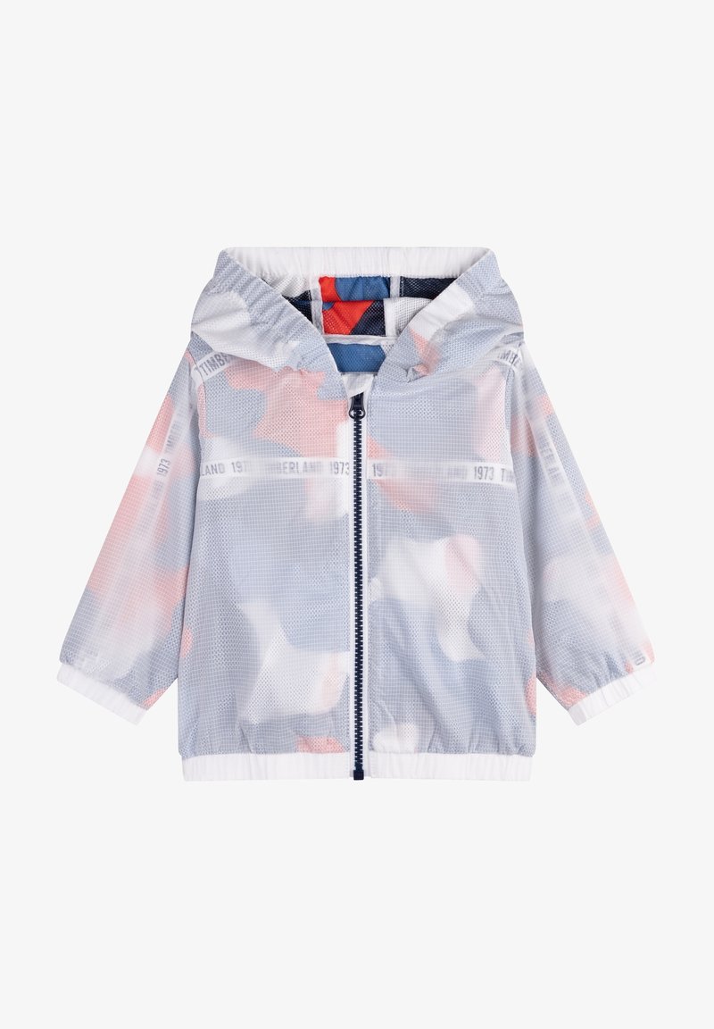 Veste à capuche en mesh gris clair avec fermeture éclair frontale, poignets et ourlet élastiques, et accents de couleur pastel doux sur le tissu en dessous.