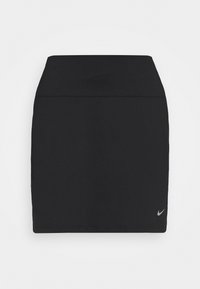 Czarna spódnica sportowa wykonana z elastycznego materiału; dopasowany krój o gładkiej fakturze, długość sięgająca do połowy uda oraz małe logo Nike na dolnym brzegu.