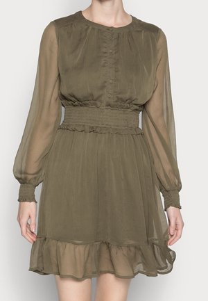 Olive green dress made of sheer fabric, featuring a round neckline, button front, long sleeves with ruffled cuffs, and a tiered ruffled hem.