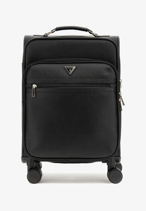 Black carry-on suitcase with textured surface, zippered front pocket, Guess logo, and four wheels for mobility. Compact and rectangular shape.