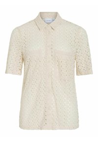 Camisa de manga corta con botones en beige claro, fabricada en un tejido con textura similar a encaje, que incluye un bolsillo en el pecho y un cuello tipo spread.