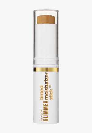 Stick hydratant teinté Revlon Glimmer avec un emballage blanc et doré et un capuchon transparent, montrant un baume teinté beige clair à l'intérieur.