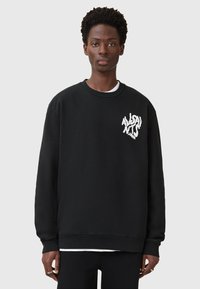 Schwarzes Sweatshirt aus Baumwolle, mit Rundhalsausschnitt, langen Ärmeln und einem weißen Grafiklogo auf der Brust. Glatte Textur, lockere Passform.