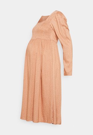 Vestido de maternidade em pêssego claro com decote quadrado, mangas bufantes longas, cintura franzida e padrão manchado de branco por todo o vestido.