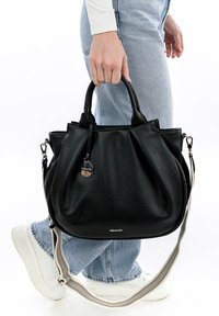Black leather handbag with a textured finish, short handles, and a detachable shoulder strap. Features a metallic tag and zipper closure.