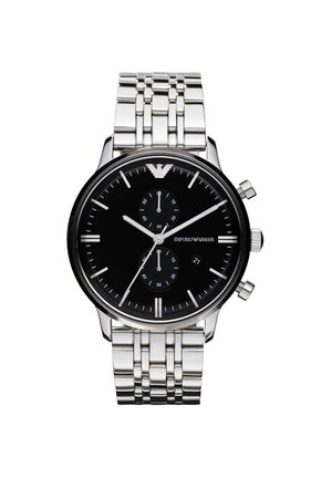 Silver metal wristwatch with black dial, two small subdials, three control buttons, and Emporio Armani logo at 12 o’clock.