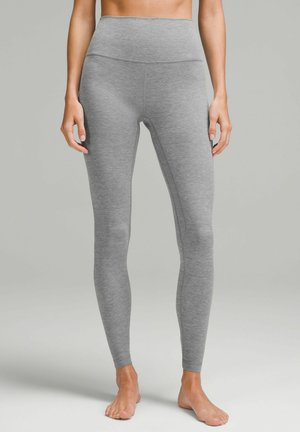 Gray high-waisted leggings made from a soft, stretchy material. Features a fitted silhouette and smooth texture without visible seams.